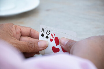 Retired people playing card in a retirement home.