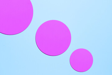 Paper blue background with shaped blue and purple elements.