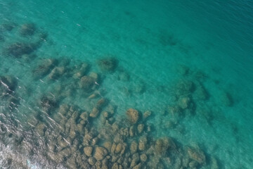 Naklejka na ściany i meble Aerial shot of clear sea water surface with sea floor