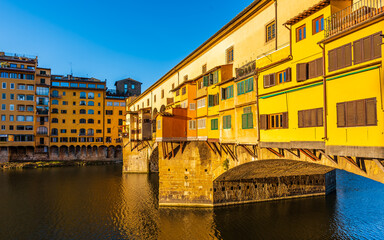 The bridge Ponte Vecchio enlighted by a strong morning sunlight in Florence.