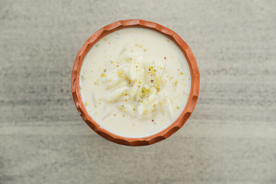 chui pitha, kheer, firni served in pot isolated on mat top view of indian, bangali and pakistani dessert mithai