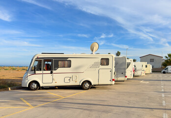 Campervan in camp parking near beach at coastline. Family rv camper van vehicle at seaside. Rving...