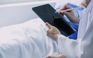 Asian caregiver doctor examine older patient use blood pressure gauge. Young woman therapist nurse at nursing home taking care of senior elderly woman sit on sofa. Medical insurance service concept