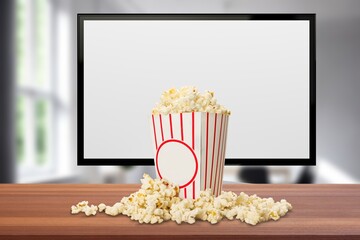 TV screen with popcorn in box on the desk