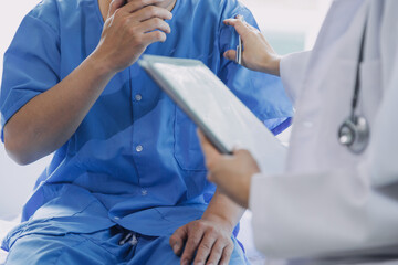 Asian caregiver doctor examine older patient use blood pressure gauge. Young woman therapist nurse at nursing home taking care of senior elderly woman sit on sofa. Medical insurance service concept