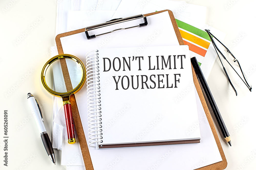 Poster don't limit yourself text on notebook with clipboard on white background
