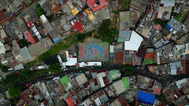 Basketball and football court field in  comuna 13 medellin colombia, 4k drone footage, aerial shot from above, Paplo escobar and graffiti tour
