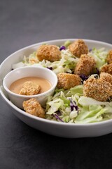 the bowl is filled with some meatballs, coleslaw and a side of