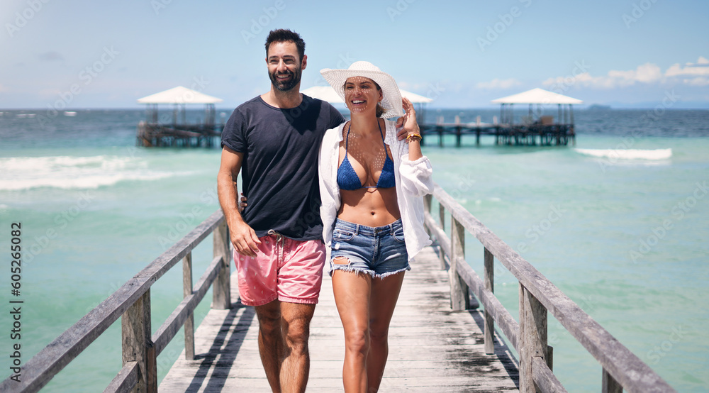 Poster Beach, island and couple walking on deck for holiday, summer vacation and tropical weekend in Maldives. Love, travel and happy man and woman on luxury resort for honeymoon, anniversary and adventure