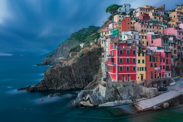 Fototapeta na wymiar Beautiful shot of a historic colorful village on a cliff near the shore of Riomaggiore, Cinque Terre