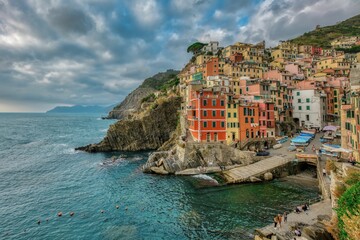 Fototapeta na wymiar Stunning view of a picturesque coastal town on the edge of a cliff in Riomaggiore, Cinque Terre