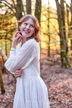 smiling redhead girl in a forest