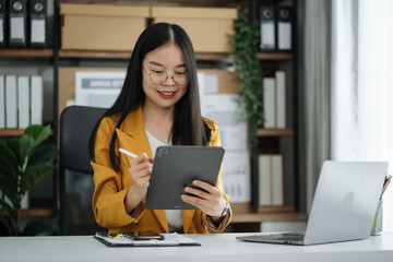 Businesswoman hand Project manager working and update tasks and Gantt chart scheduling virtual diagram.with smart phone, tablet and laptop in office.