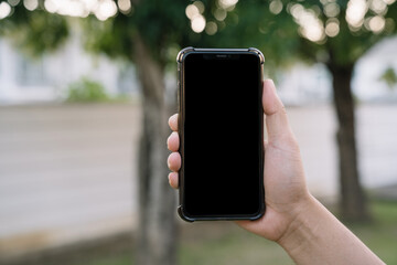 Man holding smartphone, close-up of hands. Space for text.