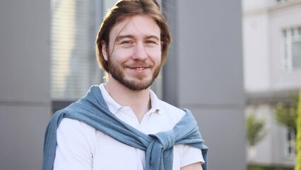 Close up portrait of carefree young blond man feeling good and satisfied enjoying great day at city street Self confidence businessman looking at the camera feel proud achievement alone
