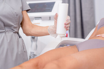 Beautician applying gel on female leg before epilation. Cosmetologist preparing woman skin for laser hair removal treatment in cosmetology clinic