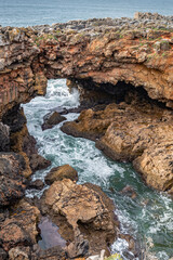 Boca do Inferno cave - Hell's mouth - cliffs and archway formed by crashing waves near Cascais, Portugal