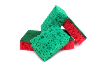 A bunch of sponges of different colors lie on a white background.