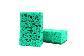 Two green sponges for washing dishes lie on a white background.
