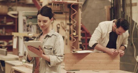 Woman, tablet and internet connection for carpentry in a workshop or small business. Female carpenter with technology for website planning, online ideas or social media for creative furniture project