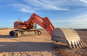 Excavator on earthmoving at open pit mining. Backhoe dig sand and gravel in quarry. Heavy...