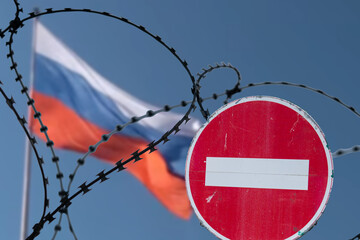 Barbed wire on background of flag of Russia. Sanctions against Russia.