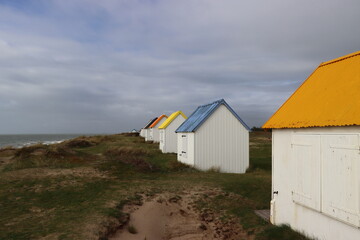 Fototapeta na wymiar Die bunten Dächer der Badehäuser an der Küste der Normandie