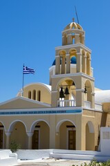 Fototapeta na wymiar Vertical view of Saint Georgios Oia Holy Orthodox Church before a blue skyline