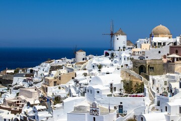 Aerial view of the marble buildings of Oia village on a sunny day
