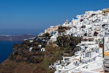 Fototapeta na wymiar Aerial view of the coastal town of Oia in Santorini, Greece in summer on a sunny day