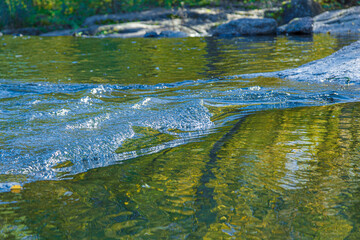 flow of water and spray from a stone