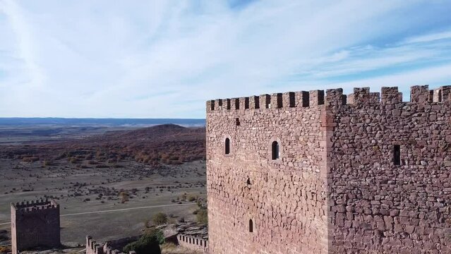 Raising drone view over Zafra Castle  tower in Campillo de Duenas in Spain with sea ion the horizon