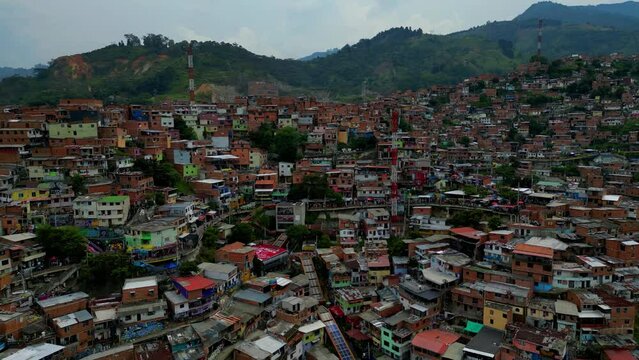 Comuna 13 Medellin Colombia escaleras electricas, graffiti and pablo escobar tour,  tourist attraction. 4k drone shot, view from above, barrio with unformal housing, favela, slum