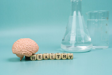 Brain on a blue background. lettering health. Place for text. White pills for memory. Chemical flasks. Drug laboratory.