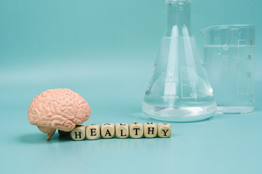 Brain on a blue background. lettering health. Place for text. White pills for memory. Chemical flasks. Drug laboratory.