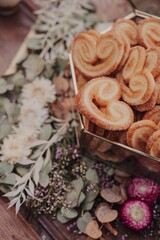 Vertical closeup of a wooden table outdoors in the park with sweets