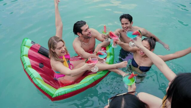 Groups of Multiculturalism Friends make an appointment to gather at  poolside party and enjoying outdoors travel holiday vacation trip at private pool villa