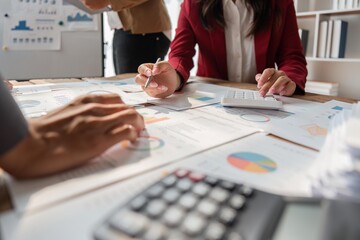Financial analyst analyzes business finance reports on laptop and graph documents during corporate meeting discussions showing successful teamwork, business meeting ideas, marketing
