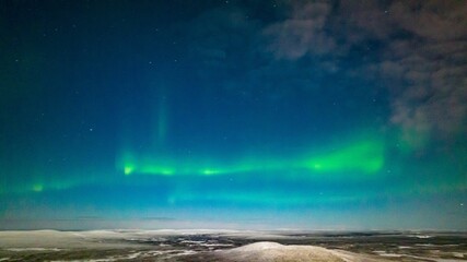 Fototapeta na wymiar Northern lights, in moon light, winter night in Lapland 01