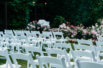 Rows of chairs on the lawn outside for a wedding ceremony