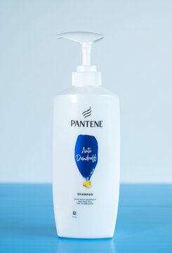 Vertical closeup of Pantene Shampoo (Anti-Dandruff) bottle isolated on white background