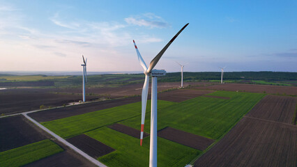 Obraz premium Windmill turbines generating green energy electric.Green energy helps reduce carbon emissions and makes earth cleaner and more ecological.