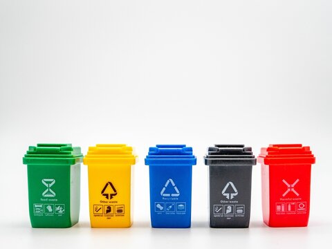 Five trash bins with different colors and tasks isolated on white background
