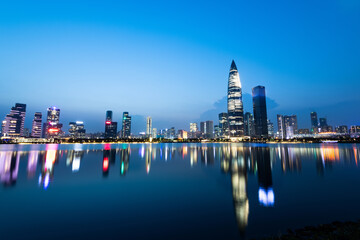 Office building reflected in the water at dusk