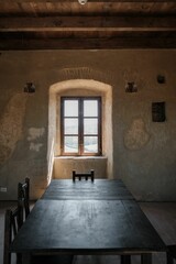 a long table with four chairs sits in a room under a large window