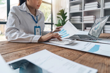 Accountant or business woman working Financial investment on calculator, calculate, analyze business and marketing growth on financial document data graph