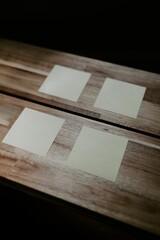 Vertical closeup of sticky note papers attached on a wooden table