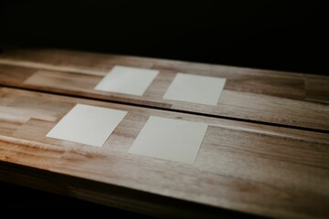 Closeup of sticky note papers attached on a wooden table