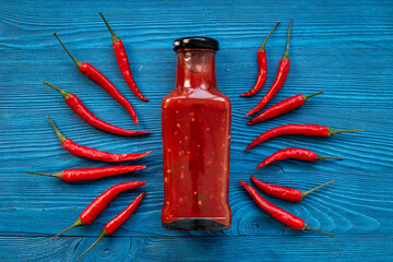 Red chili sauce ketchup or tabasco with ripe hot pepper