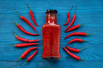 Foto op Canvas Red chili sauce ketchup or tabasco with ripe hot pepper © 9dreamstudio